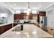 Spacious kitchen featuring an island, dark wood cabinetry, stainless steel appliances, and hardwood floors at 1404 Rosebank Dr, Westfield, IN 46074