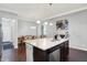 Kitchen island with stainless steel dishwasher and granite countertop, with seating area in the background at 1404 Rosebank Dr, Westfield, IN 46074