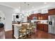 Gourmet kitchen features an island with seating, stainless steel appliances, and dark wood cabinetry at 1404 Rosebank Dr, Westfield, IN 46074