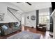 Cozy living room with hardwood floors, a comfortable gray sofa, and ample natural light at 1404 Rosebank Dr, Westfield, IN 46074