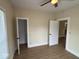 Bright bedroom with tan walls, neutral flooring and a ceiling fan at 1405 S Ribble Ave, Muncie, IN 47302