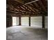 View of the inside of a three-car garage, with some cracks in the concrete floor at 1405 S Ribble Ave, Muncie, IN 47302