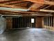 View of garage interior with exposed wood beams and one door installed at 1405 S Ribble Ave, Muncie, IN 47302