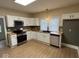Updated kitchen with white cabinets, stainless appliances, and dark countertops at 1405 S Ribble Ave, Muncie, IN 47302