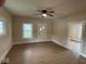 Well-lit room with wood flooring, a ceiling fan, and windows for natural light at 1405 S Ribble Ave, Muncie, IN 47302