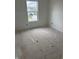 Unfinished bedroom with fresh paint and a window overlooking the neighborhood at 1439 Elm St, Martinsville, IN 46151