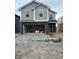 Two-story home featuring gray siding, black brick accents, and an unfinished front yard at 1439 Elm St, Martinsville, IN 46151