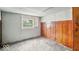 A basement features exposed walls, a window with natural light, and wood paneling at 1529 E Gimber St, Indianapolis, IN 46203