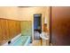 A quaint bathroom features wood paneling and vintage tiling, alongside an antique sink and a blue bathtub at 1529 E Gimber St, Indianapolis, IN 46203