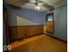 View of bedroom with wood floors, wood paneling, and one window at 1529 E Gimber St, Indianapolis, IN 46203