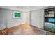 A bright bedroom features hardwood floors, white walls, and a window with an outside view at 1529 E Gimber St, Indianapolis, IN 46203