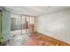 A spacious bedroom features hardwood floors, an open door, and bright natural light at 1529 E Gimber St, Indianapolis, IN 46203