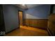 View of bedroom with wood floors, wood paneling, and closet door at 1529 E Gimber St, Indianapolis, IN 46203
