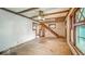 View of the living room with wood floors, exposed ceiling beams, and staircase at 1529 E Gimber St, Indianapolis, IN 46203