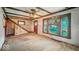 View of the living room with wood floors, staircase, and large window at 1529 E Gimber St, Indianapolis, IN 46203