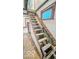 An unfinished staircase features raw wood steps and exposed structural beams, showcasing a construction renovation project at 1529 E Gimber St, Indianapolis, IN 46203
