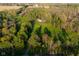 An aerial view of the home and grounds, showcasing lush landscaping and mature trees surrounding the property at 15617 Westfield Blvd, Carmel, IN 46033