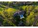 Beautiful aerial view of the landscaped property with in-ground pool surrounded by mature trees at 15617 Westfield Blvd, Carmel, IN 46033