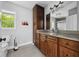 Bathroom with a granite vanity, dark wood cabinets, and modern fixtures at 15617 Westfield Blvd, Carmel, IN 46033