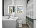Bathroom featuring a single sink vanity, shower with curtain, and bright natural light at 15617 Westfield Blvd, Carmel, IN 46033