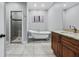 Comfortable bathroom featuring a glass enclosed shower, a claw foot tub, and granite countertops at 15617 Westfield Blvd, Carmel, IN 46033