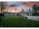 Beautiful backyard and in-ground swimming pool of single Gathering home at sunset with beautiful landscaping at 15617 Westfield Blvd, Carmel, IN 46033