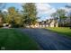 Spacious home with a three-car garage and a long driveway, framed by mature trees and a well-kept lawn at 15617 Westfield Blvd, Carmel, IN 46033
