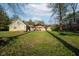 Backyard view of the home with covered outdoor seating area and lush landscaping at 15617 Westfield Blvd, Carmel, IN 46033