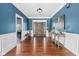 Elegant foyer with hardwood floors, blue walls with white trim, and a decorative console table at 15617 Westfield Blvd, Carmel, IN 46033