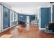 Open living space featuring hardwood floors, blue accent walls, fireplace, and view of dining and kitchen areas at 15617 Westfield Blvd, Carmel, IN 46033