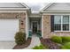 Inviting front entrance showcasing brick accents, a charming sitting area, and well-manicured landscaping at 16044 Loire Valley Dr, Fishers, IN 46037