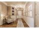 Elegant hallway featuring wood floors, decorative wall accents, and stylish lighting at 16044 Loire Valley Dr, Fishers, IN 46037