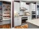 Well-organized kitchen with white cabinets, stainless steel appliances, and a walk-in pantry for ample storage at 16044 Loire Valley Dr, Fishers, IN 46037