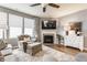 Inviting living room with a fireplace, stylish furniture, and plenty of natural light at 16044 Loire Valley Dr, Fishers, IN 46037