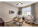 Comfortable sitting room with patterned chairs, a coffee table, and natural light from a window at 16044 Loire Valley Dr, Fishers, IN 46037