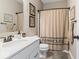 Cozy bathroom with a farmhouse-style shower curtain and white vanity at 161 Tamarack Larch Blvd, Cicero, IN 46034
