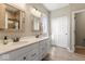 Elegant bathroom with double vanity, white cabinets, and a beautifully tiled shower at 161 Tamarack Larch Blvd, Cicero, IN 46034