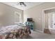 Bright bedroom featuring a floral comforter, ceiling fan, and a blue bookshelf at 161 Tamarack Larch Blvd, Cicero, IN 46034