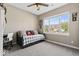 Brightly lit bedroom with a large window, ceiling fan, and a study desk at 161 Tamarack Larch Blvd, Cicero, IN 46034