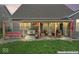 Charming covered patio with swing, grill, and outdoor seating area, perfect for entertaining or relaxing at 161 Tamarack Larch Blvd, Cicero, IN 46034