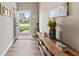 Inviting entryway with hardwood floors, rustic console table, and view to the front yard at 161 Tamarack Larch Blvd, Cicero, IN 46034