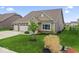 Attractive home with an attached three-car garage, a green lawn, and lovely landscaping at 161 Tamarack Larch Blvd, Cicero, IN 46034