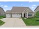 Charming single-story home featuring a three-car garage, well-kept lawn, and covered porch at 161 Tamarack Larch Blvd, Cicero, IN 46034