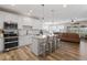 Spacious kitchen with island seating that flows into the open living room at 161 Tamarack Larch Blvd, Cicero, IN 46034