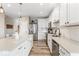 Modern kitchen with stainless steel appliances, white cabinets, a center island and wood floors at 161 Tamarack Larch Blvd, Cicero, IN 46034