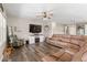 Comfortable living room with a large television, fireplace, and a view into the kitchen at 161 Tamarack Larch Blvd, Cicero, IN 46034