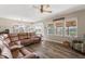 Spacious living room featuring a leather sectional, wood floors, and plenty of natural light at 161 Tamarack Larch Blvd, Cicero, IN 46034