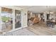 Open-concept living area with hardwood floors, a leather sofa, and access to an outdoor patio at 161 Tamarack Larch Blvd, Cicero, IN 46034
