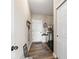 Functional mudroom with a coat rack, storage shelves, and a laundry area at 161 Tamarack Larch Blvd, Cicero, IN 46034