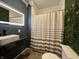 Modern bathroom featuring a sleek vanity, illuminated mirror, and stylish shower curtain at 1622 S Randolph St, Indianapolis, IN 46203